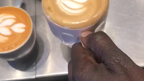 Coffee shops vibes , barista making a succulent cappuccino with latte art
