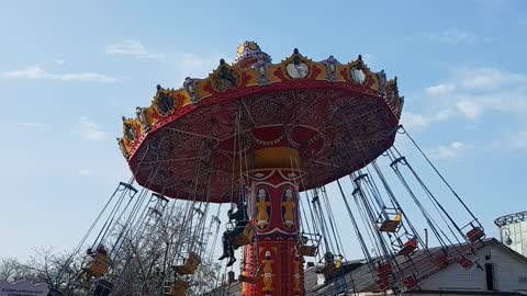 children enjoying rides in amusement pakrs.