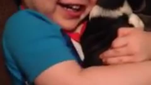 Toddler shows how much he loves his new puppy