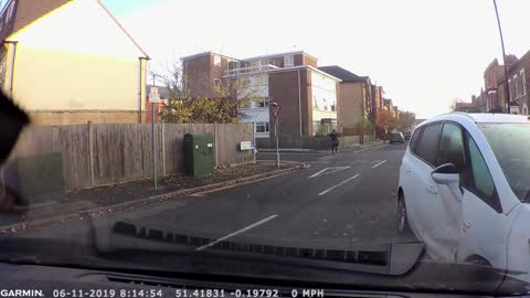 Woman doesn't give way at junction then crashes and starts swearing