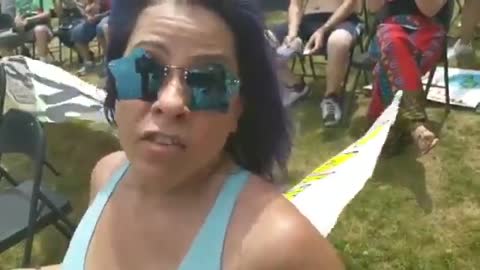 Woman with sign at Fourth of July festivities