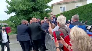 The moment Macron gets slapped during meet-and-greet
