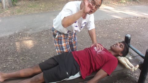 Luodong Massages Young Man On Park Bench