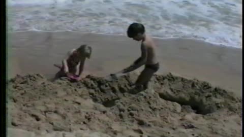 Kid's Sand Castle Becomes A Moat After Surprise Wave