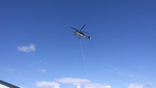 Helicopter is dropping off something at the steen river fire base in northern alberta