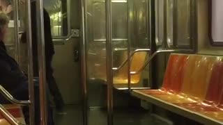 Old man black jacket dancing in empty subway car