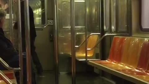 Old man black jacket dancing in empty subway car