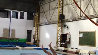 Shirtless guy gymnastics hanging rings balance fail