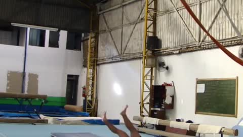 Shirtless guy gymnastics hanging rings balance fail