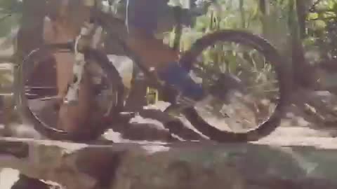 Guy blue long sleeve shirt rides bike on rocks lands head first into dirt falls off bike