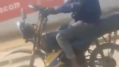 African Rides a motorcycle using steering and hand gear.