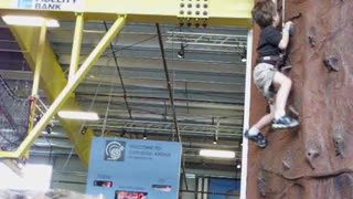 7 year old Joshua climbing rock wall.