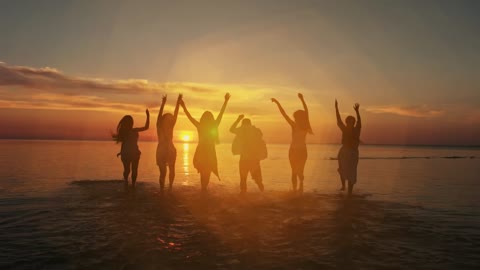 Friends enjoying sunset on the seashore