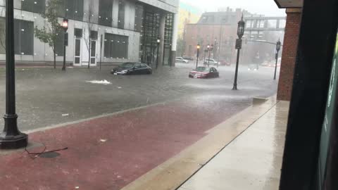 Man Uses Cup to Remove Water From His Waterlogged Car on Flooded Street