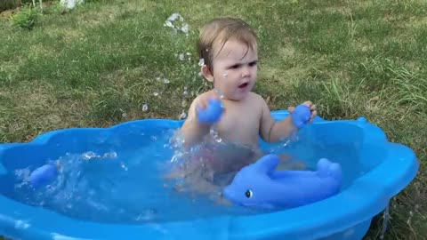 Cute_Baby_Playing_with_Water_in_Baby_Pool