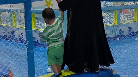 Mother and son playing at indoor playground