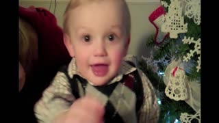 Little boy rocks deck the halls in his best cristmas attire