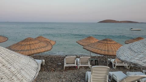 10 mins of A Beautiful sound of the waves, Lines Of Beach Chairs Shaded By Rattan Umbrellas