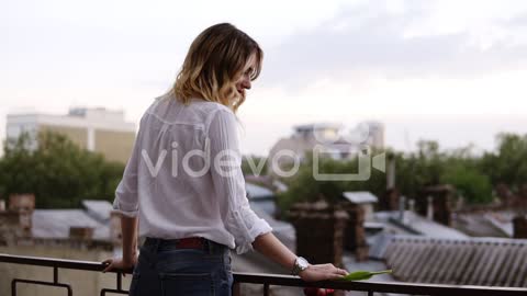 View From Behind Of Beautiful Woman Stands On The Balcony Or Terrace In Apartment At Day Time