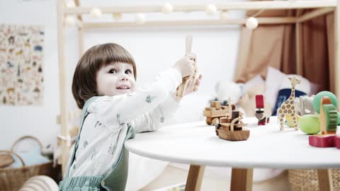 cute girl playing with wooden toys