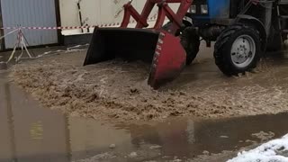 Hard Russian tractor accelerates puddle