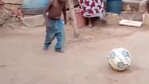 Funny boy playing with football cant stop laughing