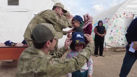 Soldiers Hand Out Caps To Children In Affected Areas