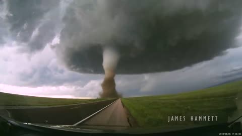 Storm chasing dashcam: Tornado crossing the highway! Laramie, Wyoming