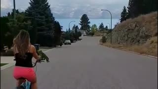 Parrot rides on bike's handlebars during majestic scenic ride