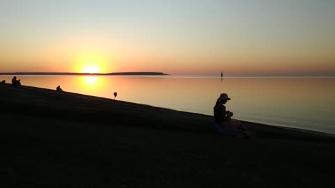 Lovers walking on the beach in the sunset