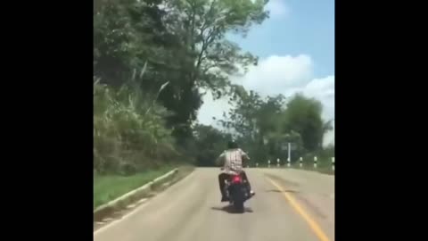 Snake tries to attack man on bike