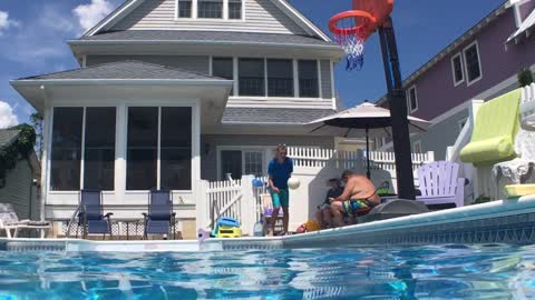 Talented kid scores a perfect slam dunk while jumping into pool