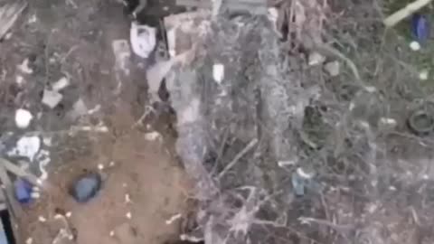 A Ukrainian militant tries to crawl deeper into the trench, but a grenade arrives right on his ass