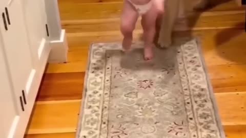 Cute baby enjoys playing with dog