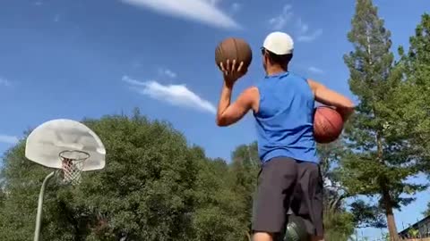 Man Makes Basketballs Shots Relentlessly While Balancing on Balance Board