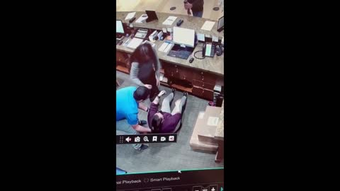 Front desk employee falls over after epic coworker prank