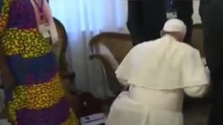 The Pope kissing the feet of black people.