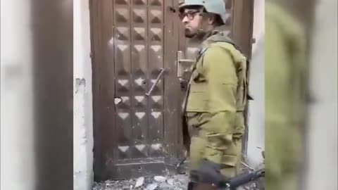 Israeli soldier mockingly knocks on a door