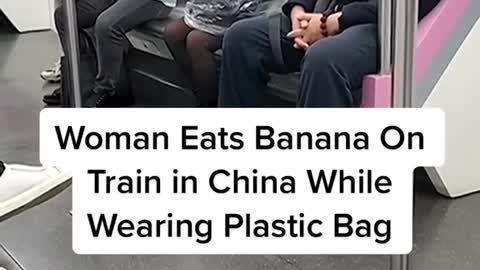Woman Eats Banana OnTrain in China WhileWearing Plastic Bag