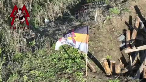 Soldiers of the DPR's Sparta Battalion have raised their flag atop a former Ukrainian strongpoint