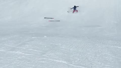 Person Falls And Tumbles Down Snow Slope While Skiing