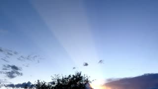 Light Beam From Setting Sun Shoots Across Sky