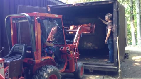 Daniel picking the bale with our Kubota B7300 and loading it into the truck box.