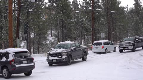 Cars sliding on Maple Lane after recent snowfall in Big Bear, CA
