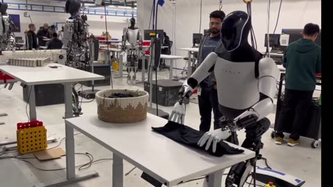 Tesla Robot Tesla Optimus Robot Folds Shirts - January 2024