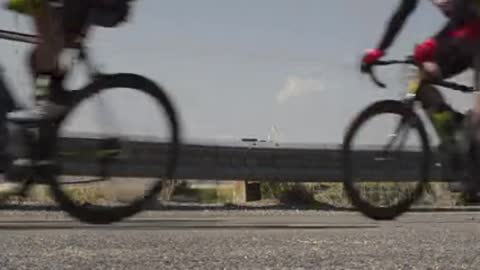 Cyclists Racing A group of cyclists passing along a road during a race.