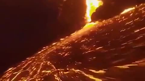 Incredible drone footage flying over a volcano and lava flows at night, captured by