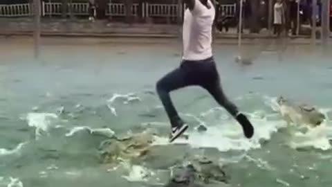 Boy Hanging between Crocodile