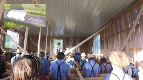 150 Amish men work together to move an abandoned building in New York