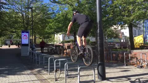 Guy Falls Straight On His Butt On A Metal Bar While Performing A Bicycle Stunt